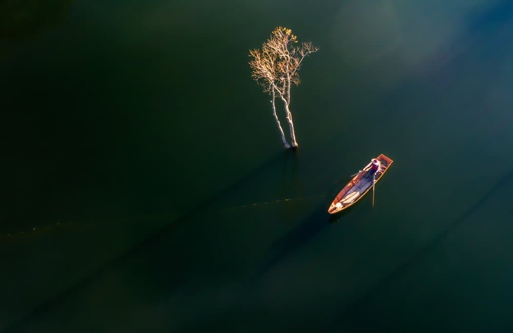 Solitary Boat Still Water by Nguyen Tan Tuan — canvas wall art
