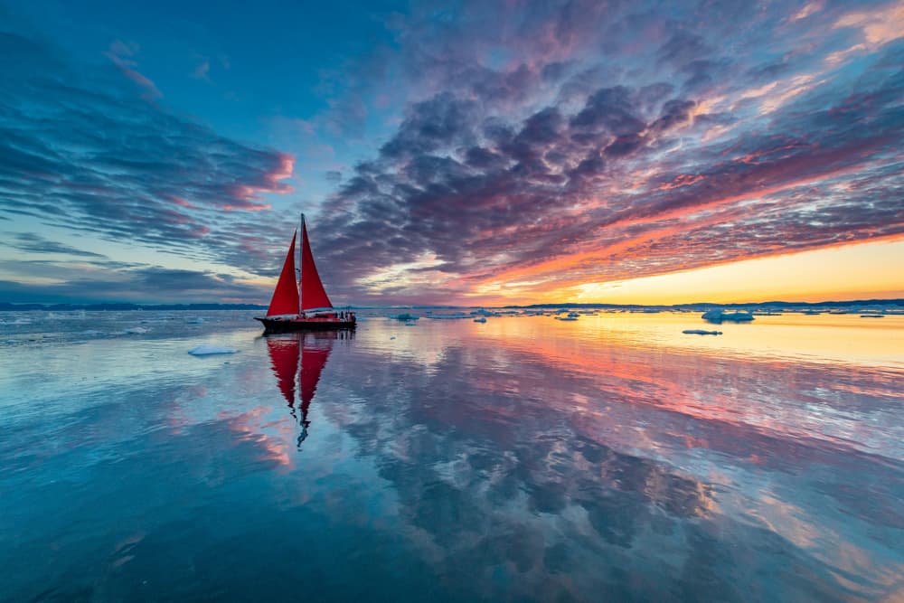 Red Sailboat Sunset Reflection by Marc Pelissier — canvas wall art