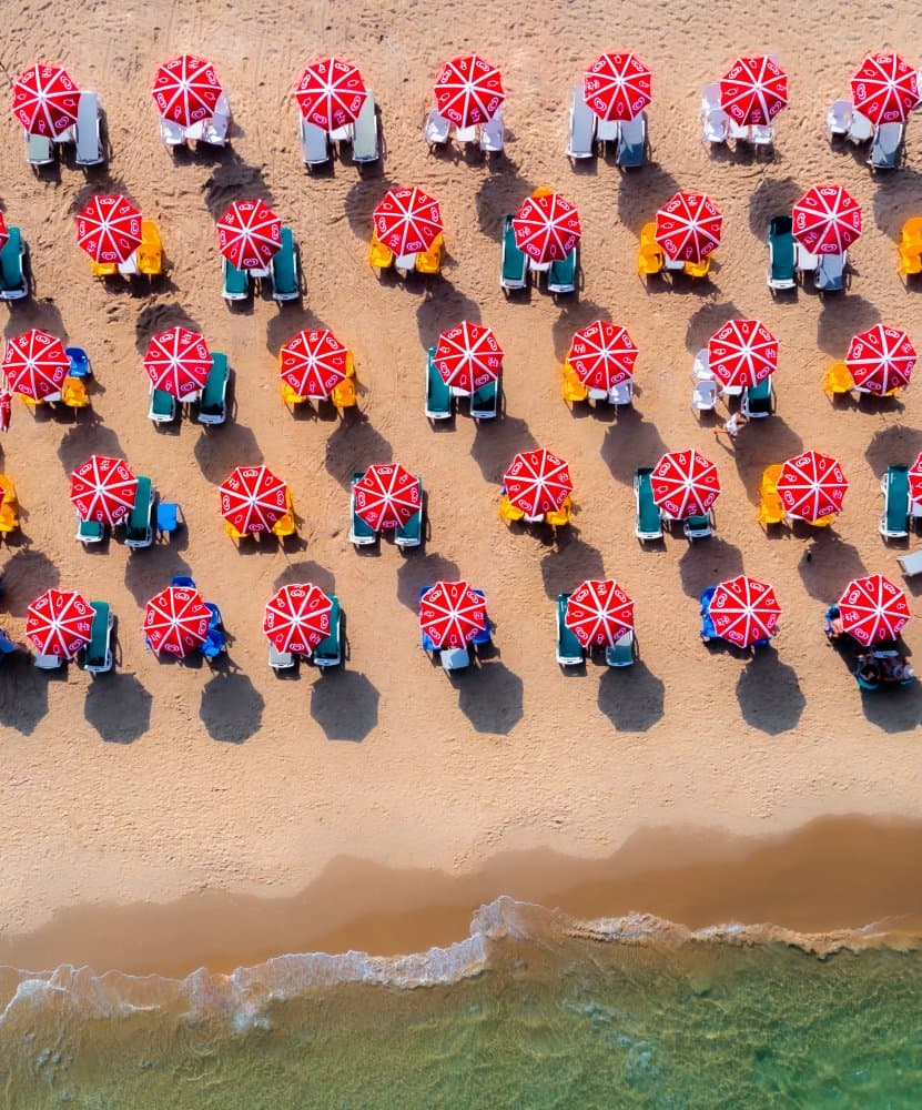 Red Umbrellas Beach Day by Gilad Topaz — canvas wall art