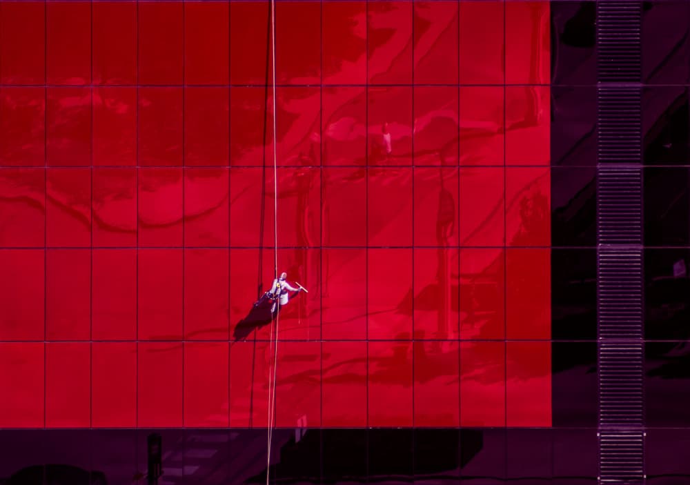 Window Cleaner Red Building by Marek Lapa — canvas wall art