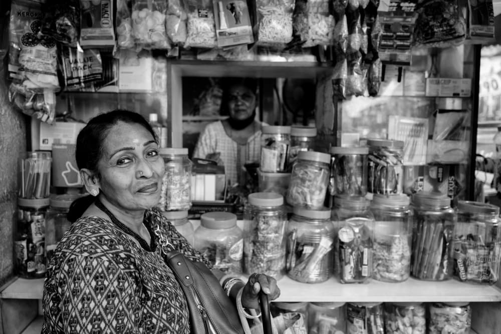 Smiling Indian Shopkeeper by Kieron Long — canvas wall art