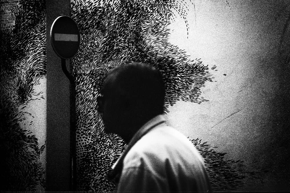 Man By Textured Wall by Paulo Abrantes — canvas wall art
