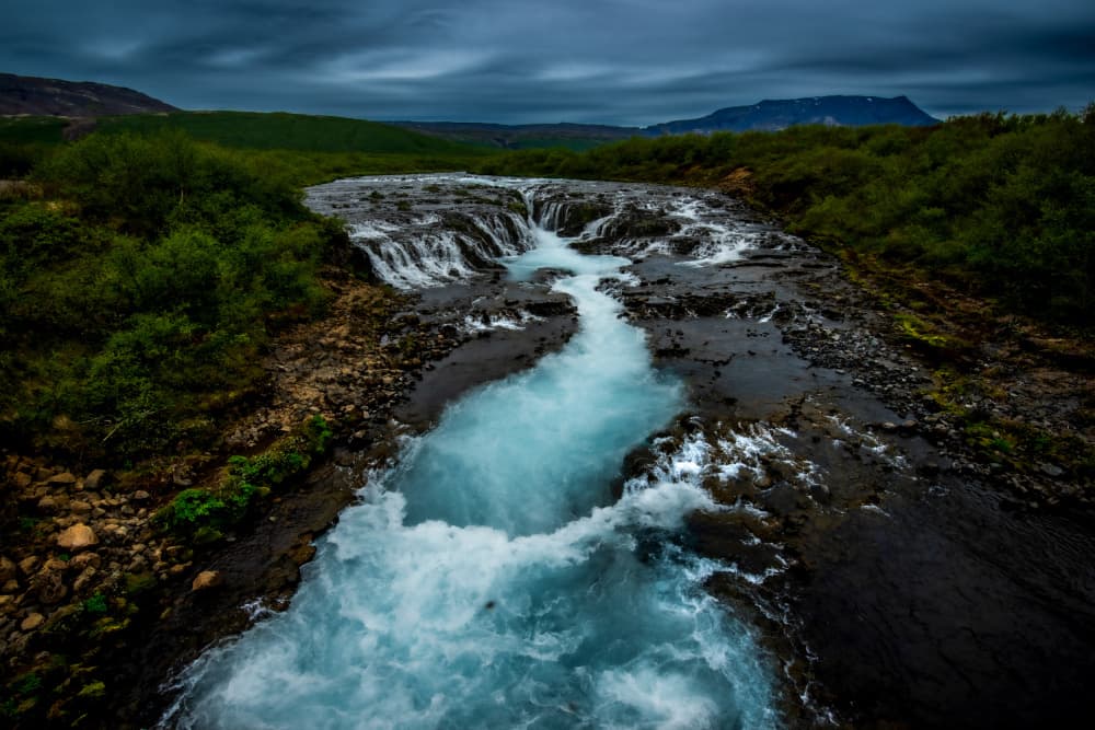 Blue River Under Dark Sky by Erik Engström — canvas wall art