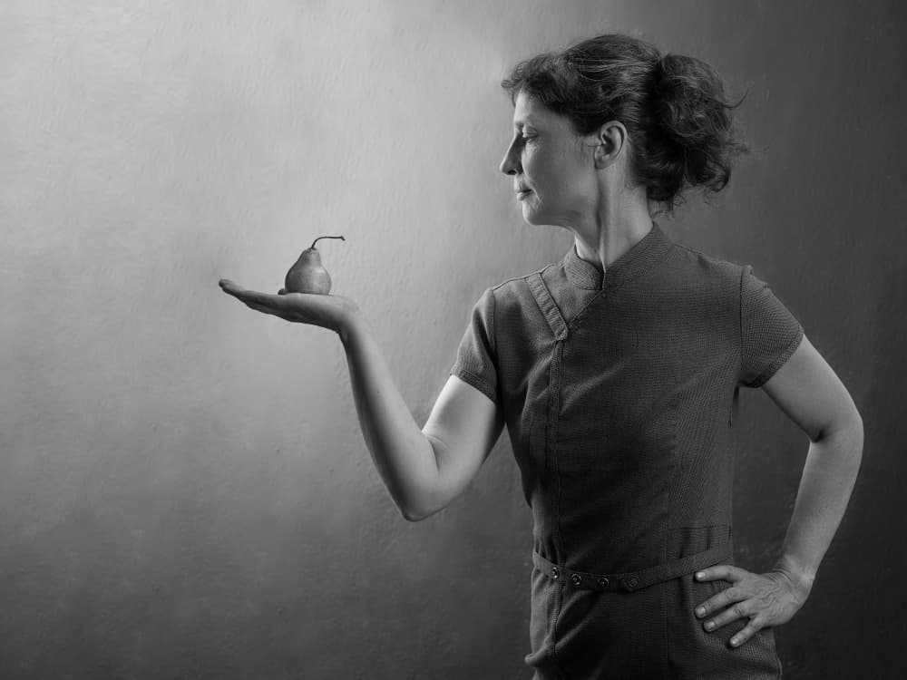 Graceful Woman Holding Pear by Michael Allmaier — canvas wall art