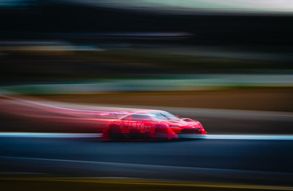 Speeding Red Race Car by Haruaki Taguchi — canvas wall art