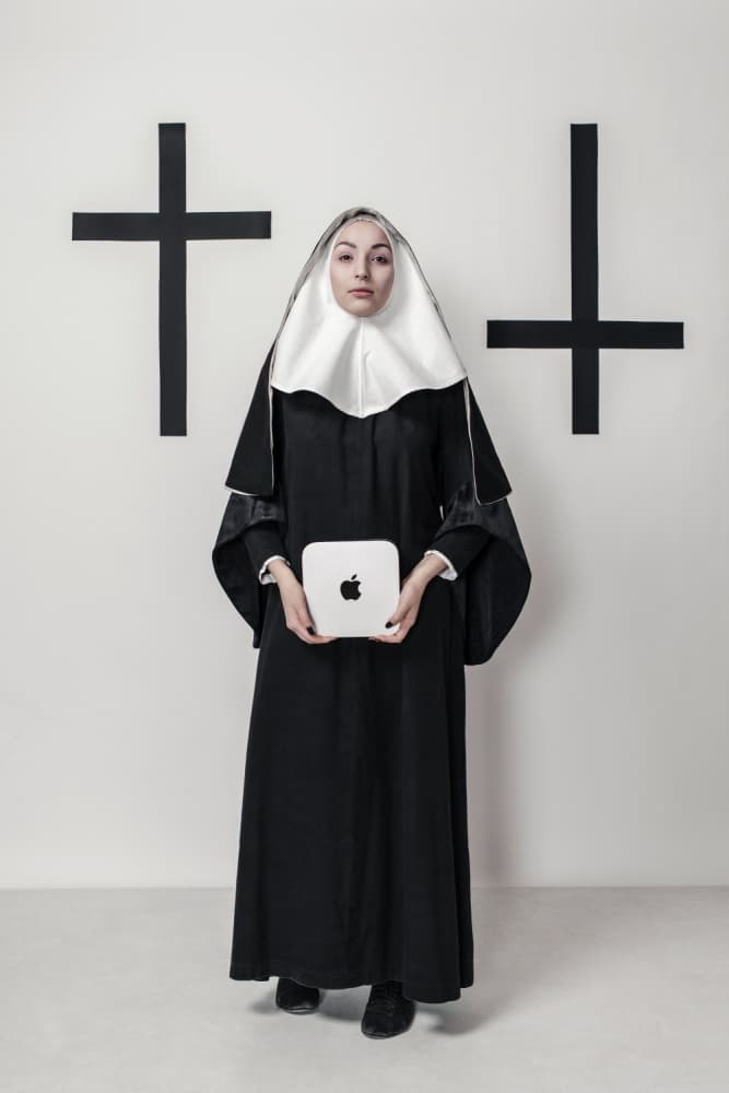 Nun Holding Mac Mini by Photographer — canvas wall art