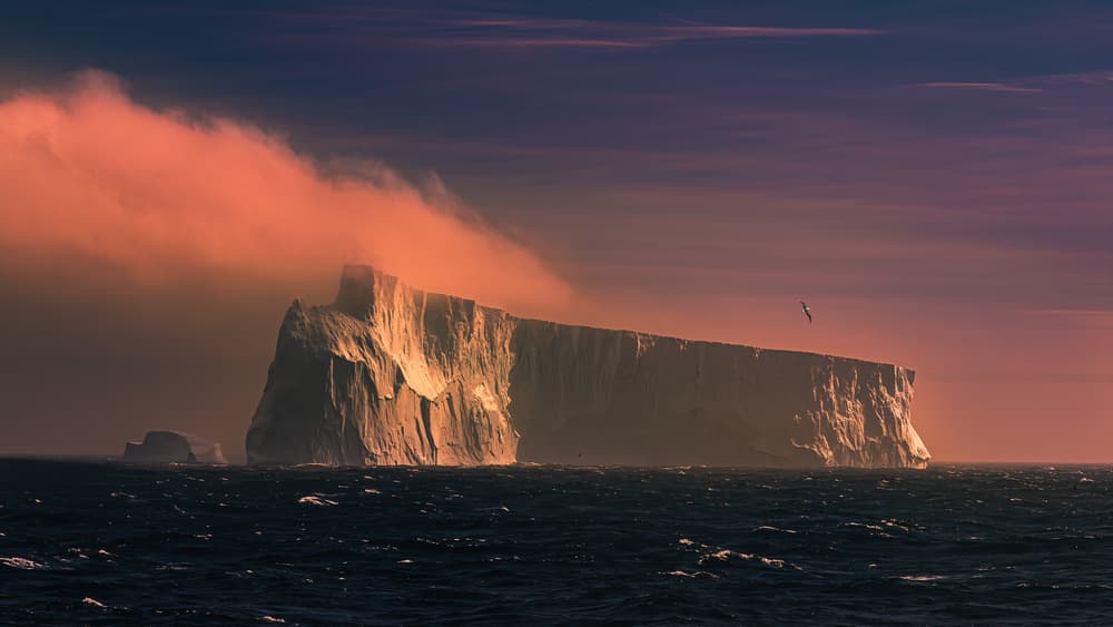 Dramatic Iceberg Glow by James Cai — canvas wall art