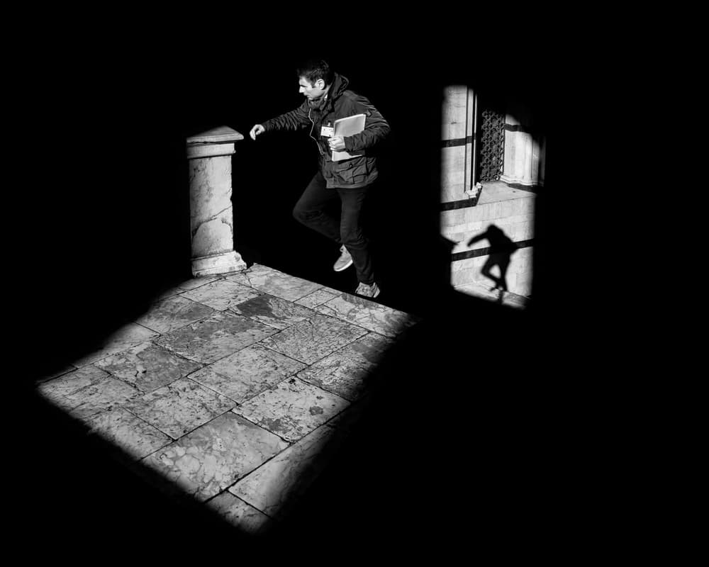 Man Walking Through Shadow by Luca Domenichi — canvas wall art