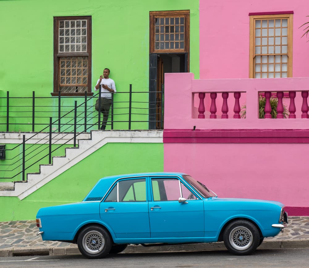 Blue Car Colorful Buildings by Jean Vandijck — canvas wall art