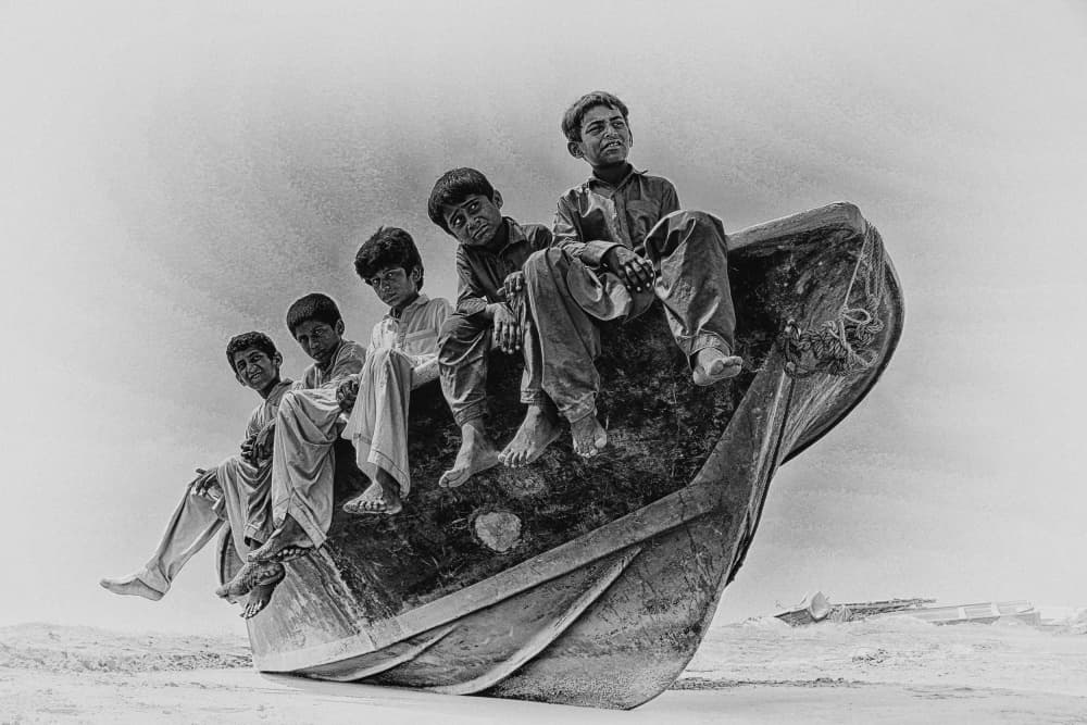 Five Boys Beached Boat by Marjan Taghipour — canvas wall art