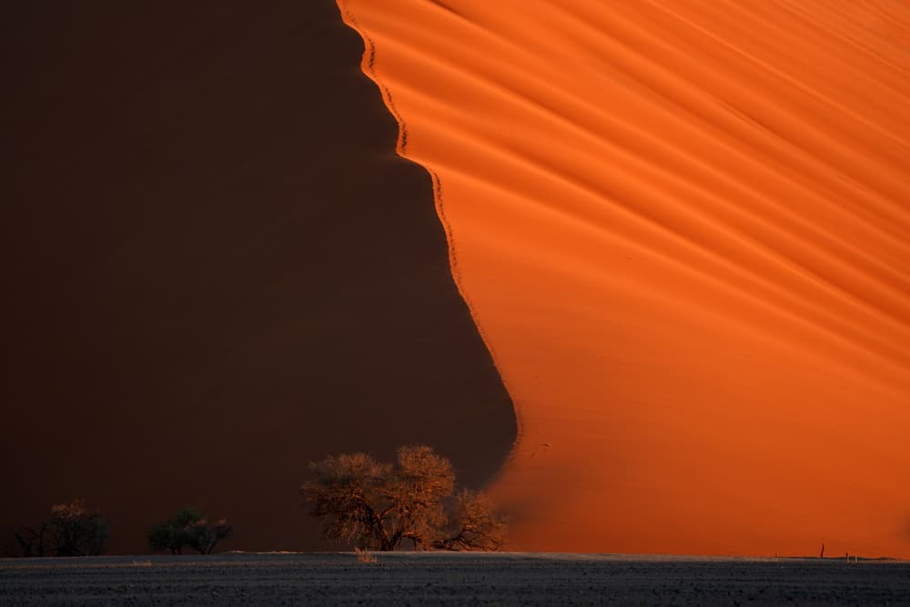 Orange Sunlit Dune by Sarawut Intarob — canvas wall art