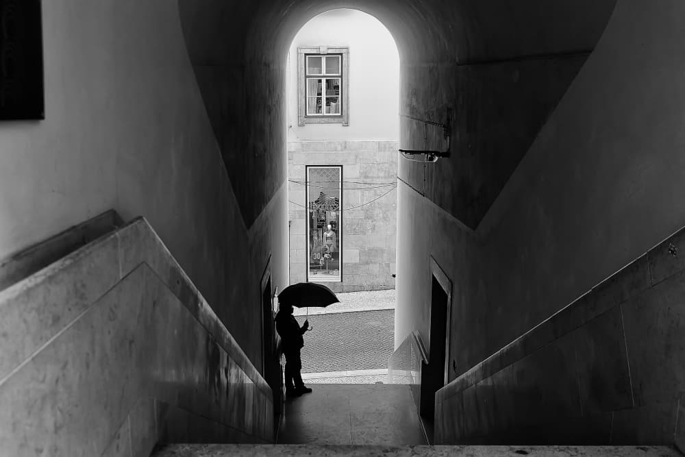 Umbrella In City Archway by Josefina Melo — canvas wall art