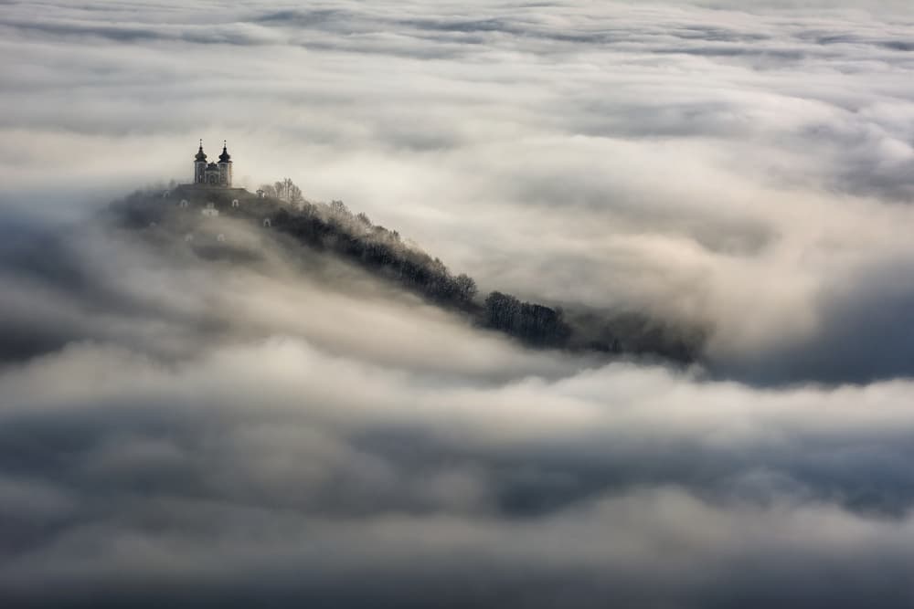 Church Above Clouds by Peter Kováčik — canvas wall art