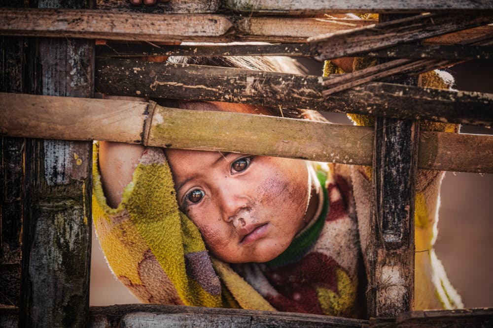 Pensive Child Through Fence by Marco Tagliarino — canvas wall art