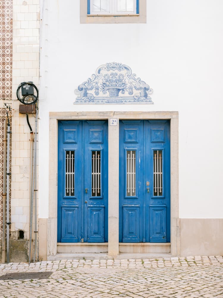 Blue Doors Of Ericeira by Raisa Zwart — canvas wall art