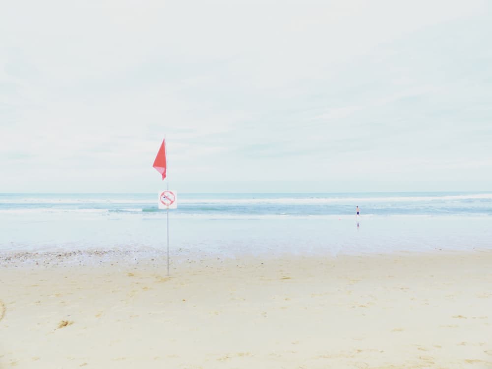 Red Flag Beach by annehedelin — canvas wall art