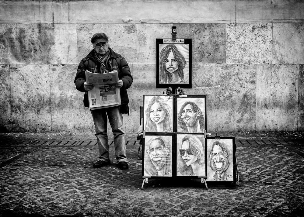 Street Artist Reading Newspaper by Riccardo Lucidi — canvas wall art