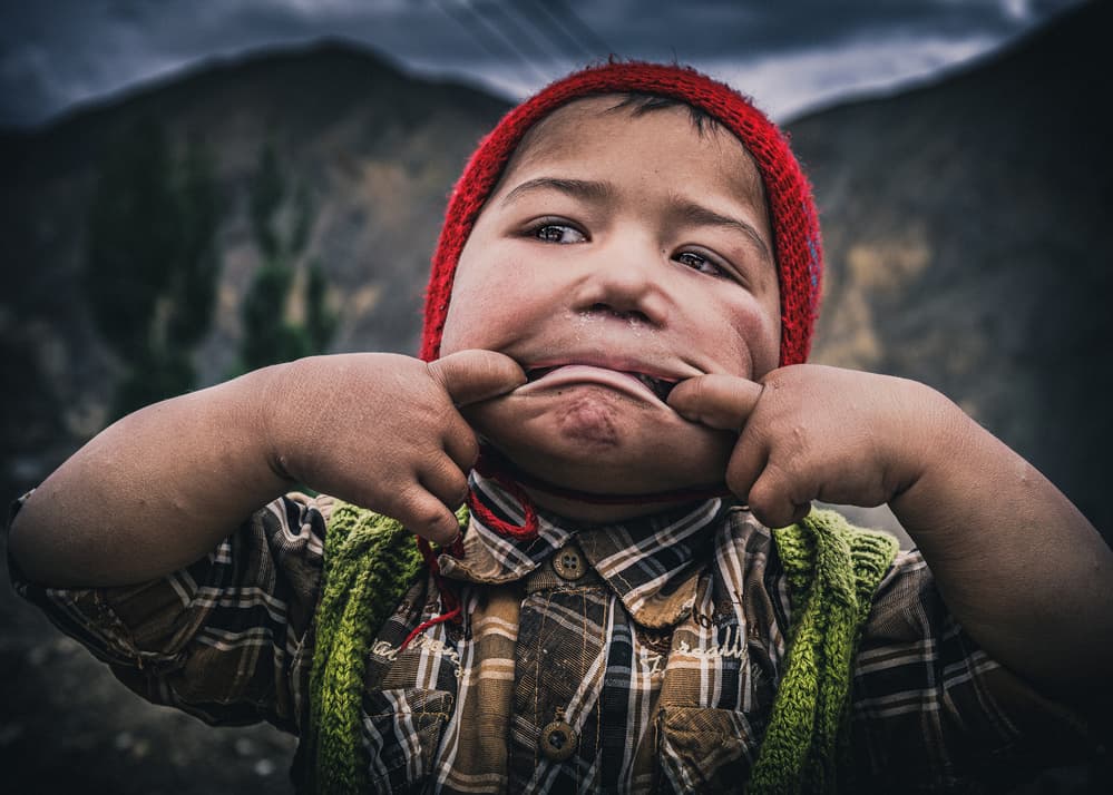 Playful Child Funny Face by Marco Tagliarino — canvas wall art