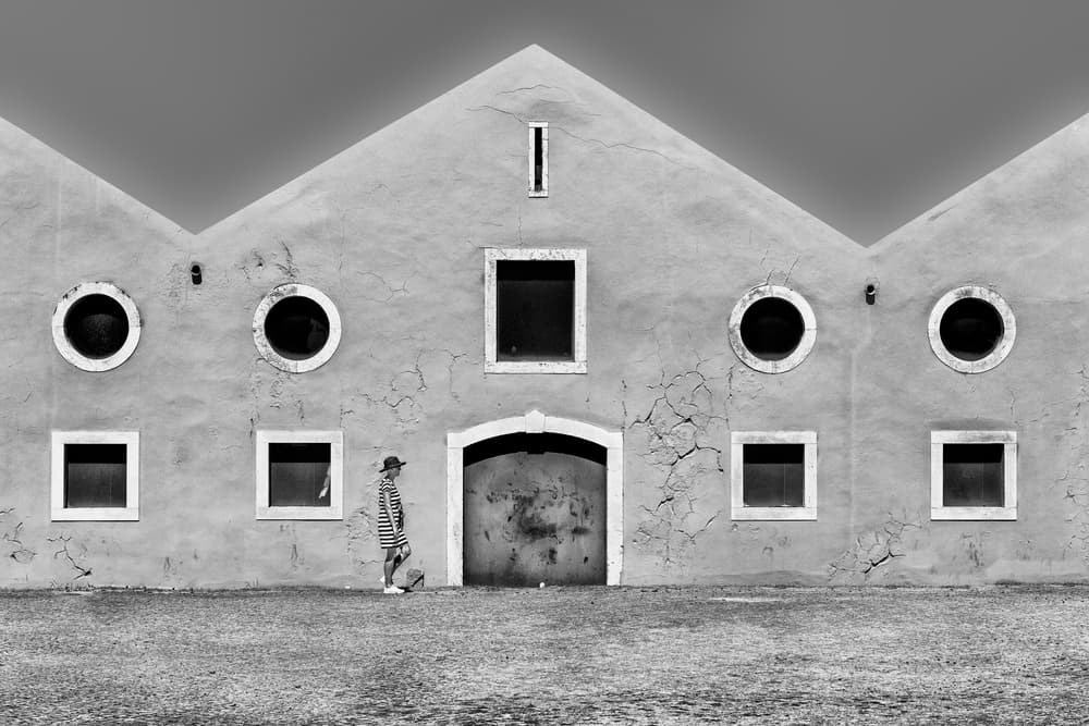 Geometric Building Lone Man by Wayne Pearson — canvas wall art