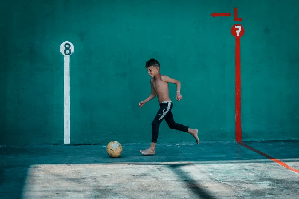Barefoot Soccer Boy by Andy Bauer — canvas wall art