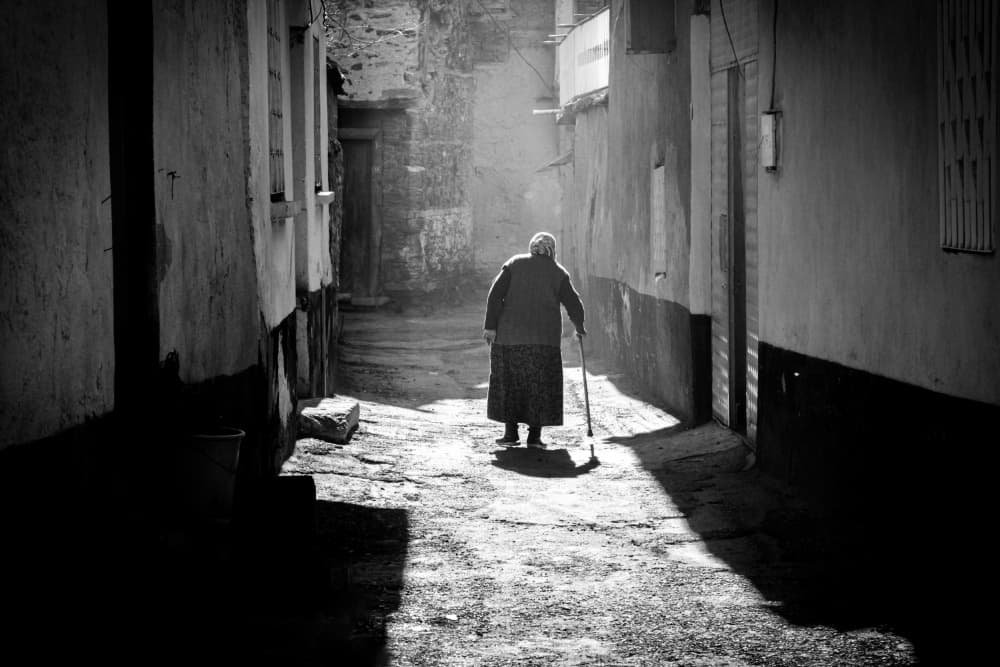 Elderly Woman Sunlit Path by Seray AK — canvas wall art