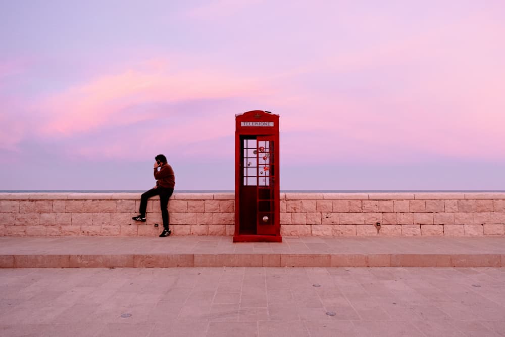 Red Phone Booth Pink Sky by Vito Muolo — canvas wall art