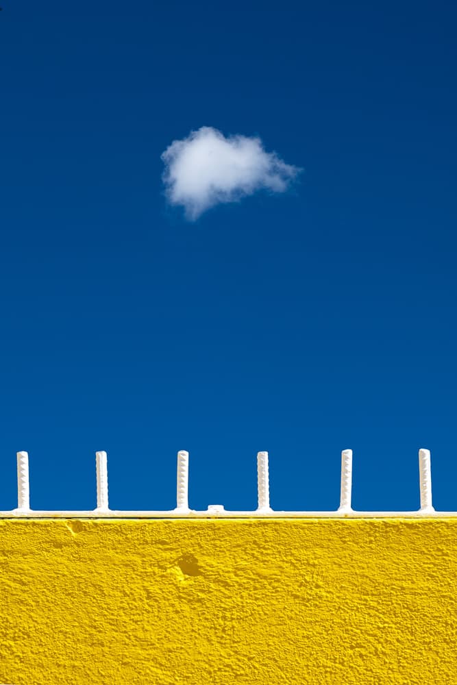 Yellow Wall Blue Sky by Rolf Endermann — canvas wall art