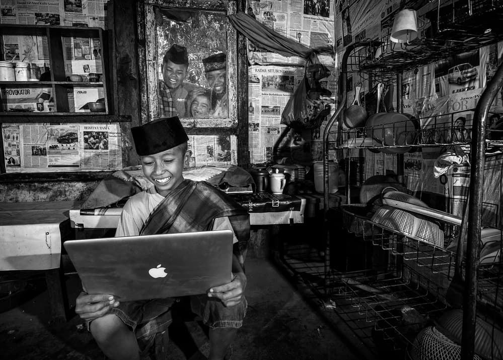 Smiling Boy with Laptop by Arief Siswandhono — canvas wall art