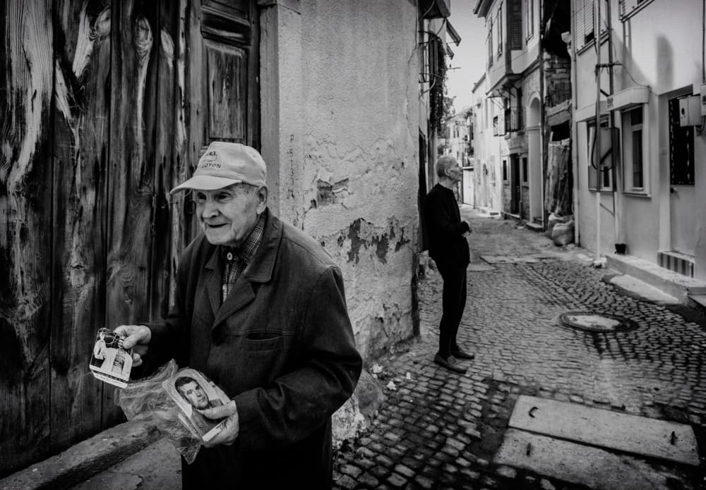 Old Man With Photos by Ömer Ates Kızıltug — canvas wall art