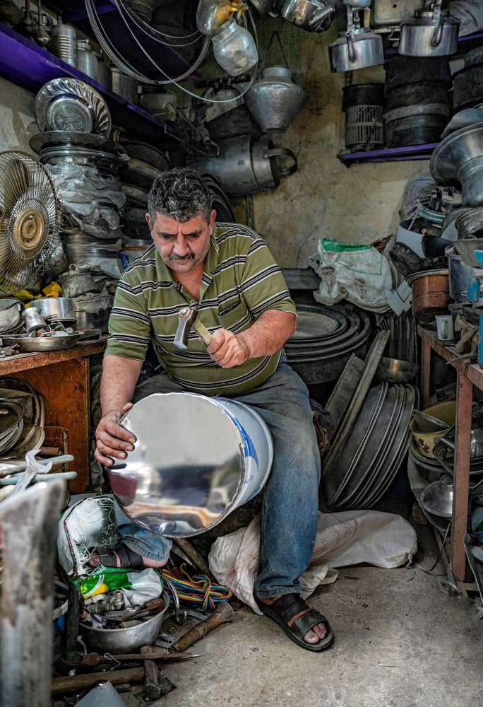 Artisan Shaping Metal by Bashar Alsofey — canvas wall art