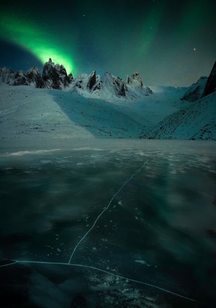 Green Aurora Over Peaks by Yan Zhang — canvas wall art