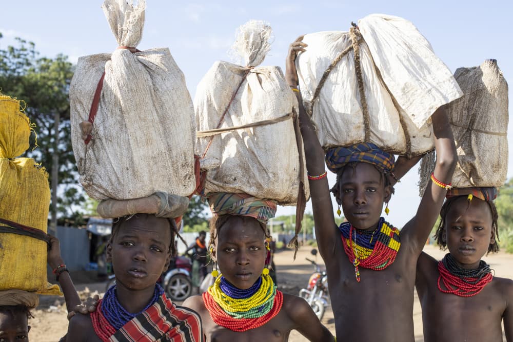 African Girls Carrying Loads by Iris Wiener — canvas wall art