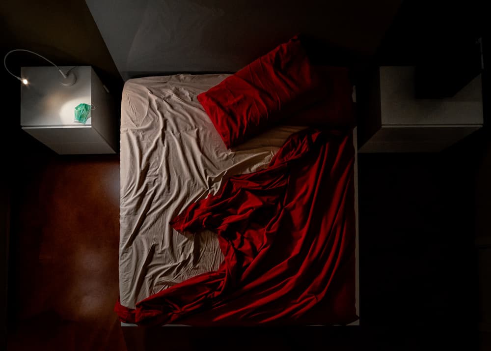 Red Sheets Unmade Bed by Luca Domenichi — canvas wall art