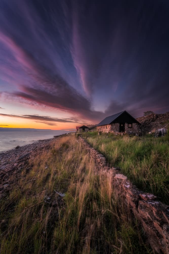 Coastal Stone Cabin Sunset by Ludwig Riml — canvas wall art