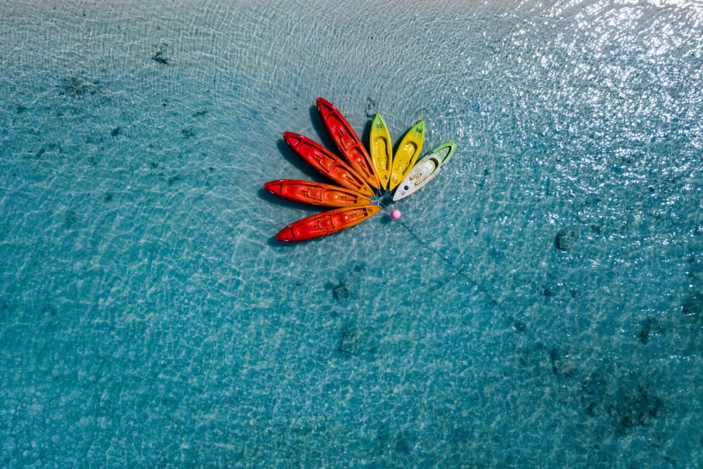 Colorful Kayaks Clear Water by Andrea Izzotti — canvas wall art