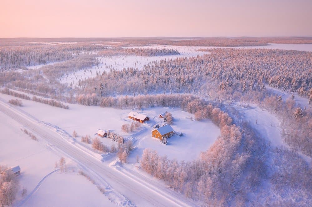 Snowy Cabins Winter Glow by Cuma Cevik — canvas wall art