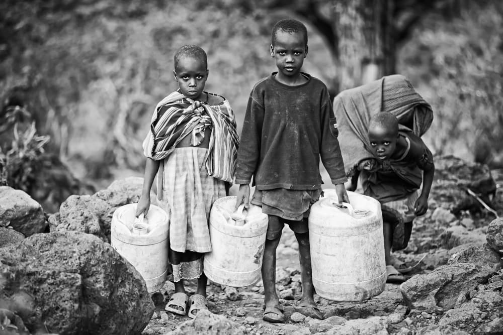 African Children Carrying Water by Goran Jovic — canvas wall art