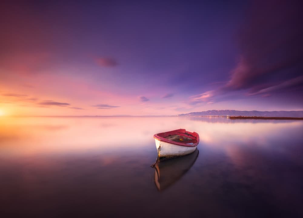 Serene Sunset Boat by joanaduenas — canvas wall art