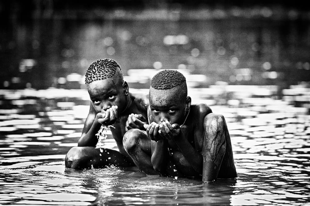 Boys Drinking Water by Vedran Vidak — canvas wall art