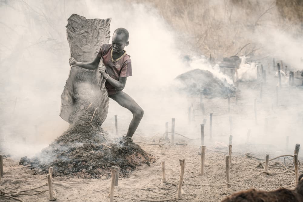African Boy Carrying Charcoal by Trevor Cole — canvas wall art