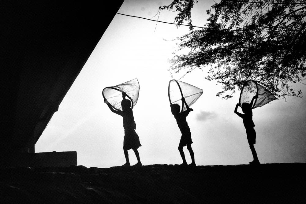 Playing Children Silhouettes by Avishek Das — canvas wall art
