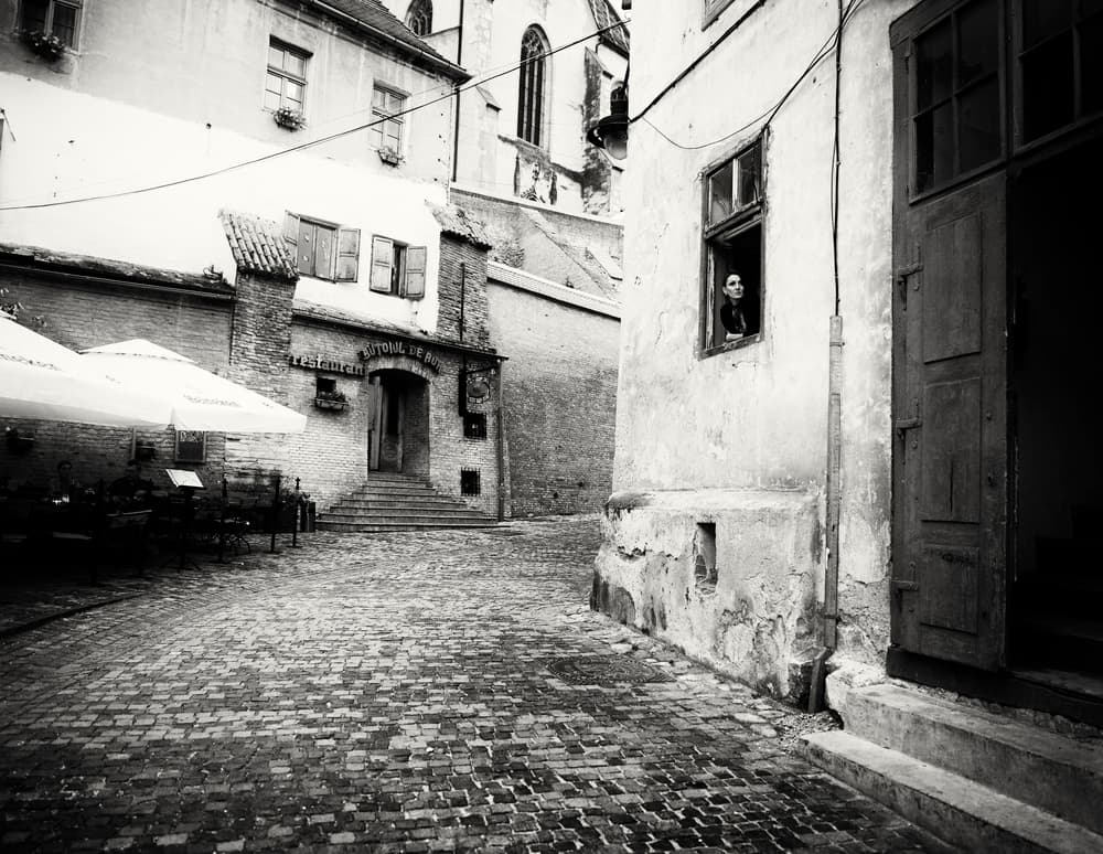 Window Watcher Cobblestone Street by Julien Oncete — canvas wall art