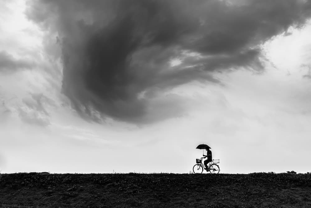 Lone Cyclist Under Dramatic Sky by Tetsuya Hashimoto — canvas wall art