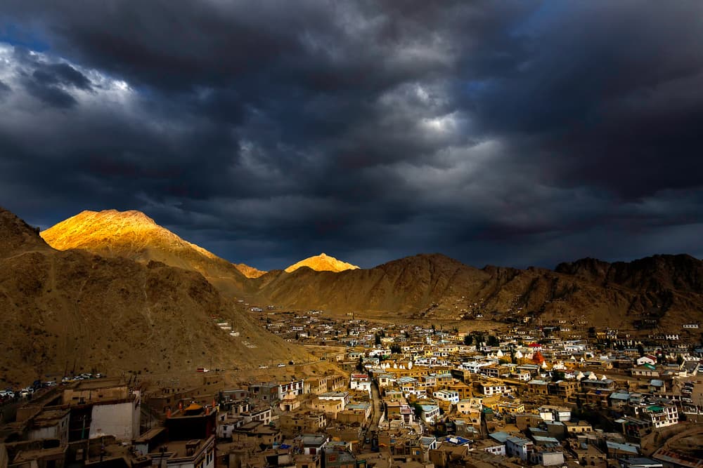 Golden Peaks Over City by Jassi Oberai — canvas wall art