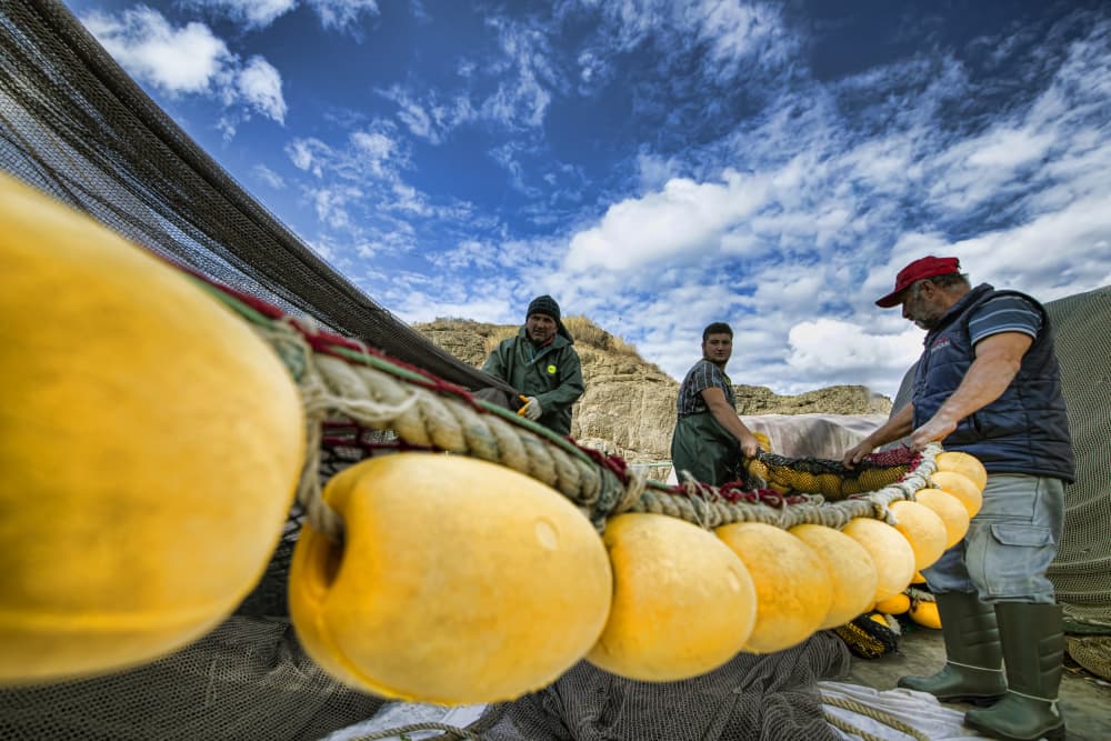 Fishermen Mending Nets by Gulsen Yilman — canvas wall art