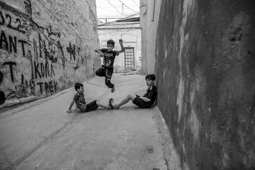 Boys Jumping in Alley by Jalili — canvas wall art