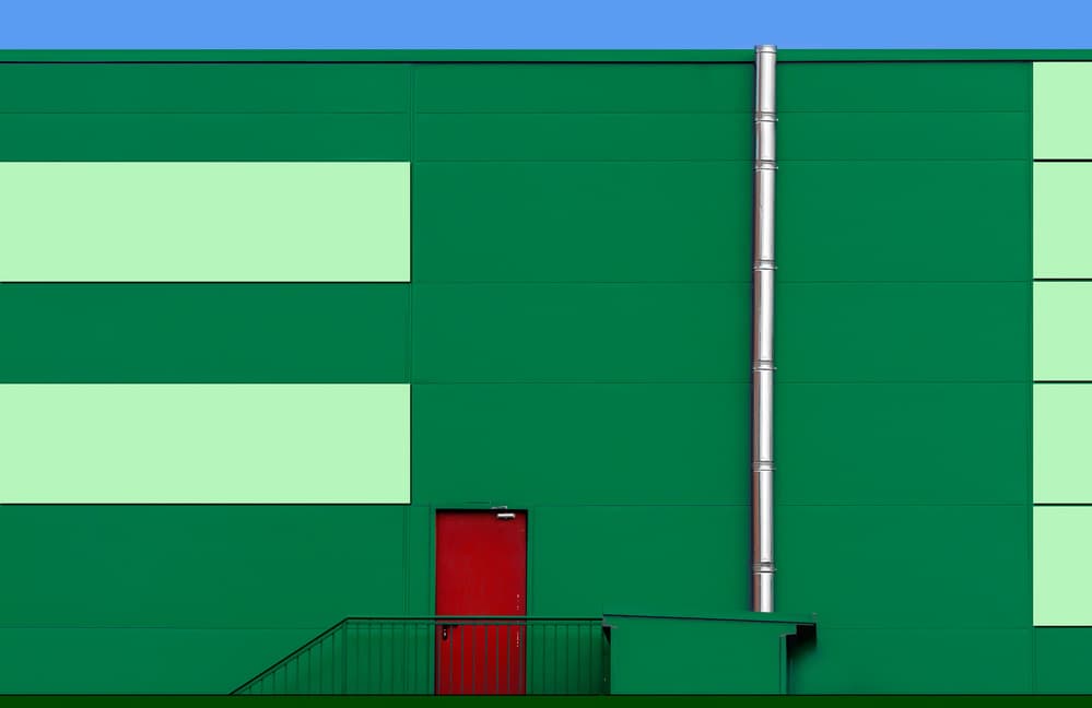 Green Building Red Door by Alfonso Novillo — canvas wall art