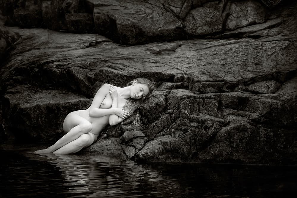 Serene Figure on Rocks by Hugh Wilkinson — canvas wall art