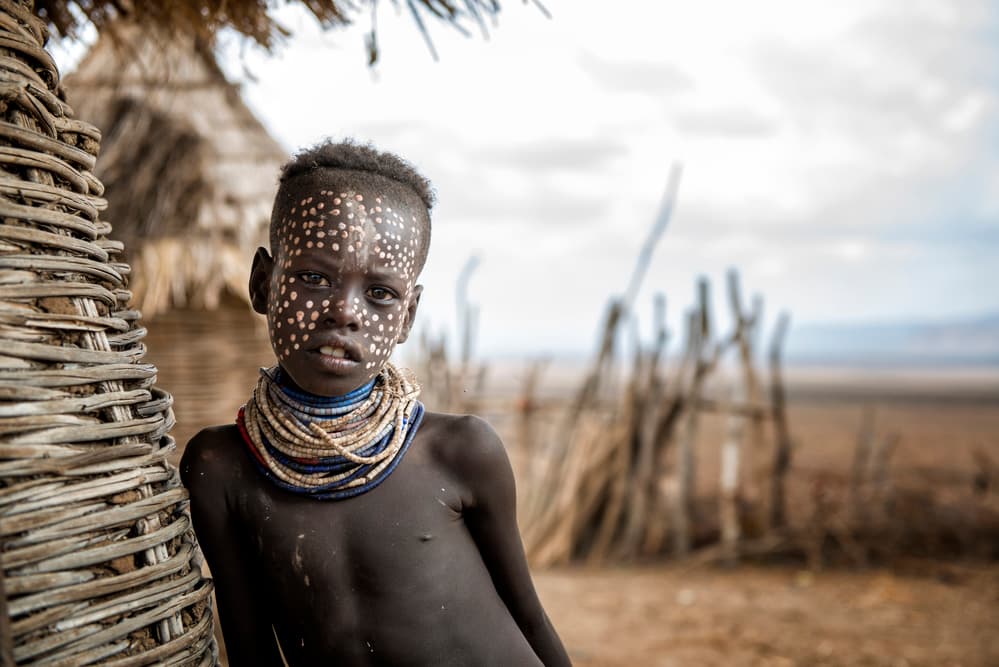 African Child Face Paint by Mohammed Al Sulaili — canvas wall art