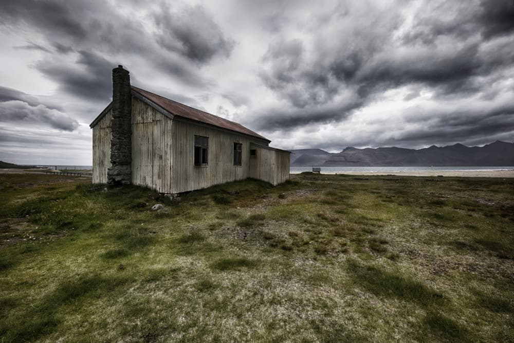 Rustic House Under Stormy Sky by Þorsteinn H. Ingibergsson — canvas wall art